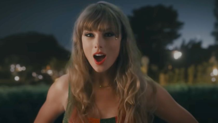 Taylor Swift standing with her mouth open in the Anti-Hero music video.