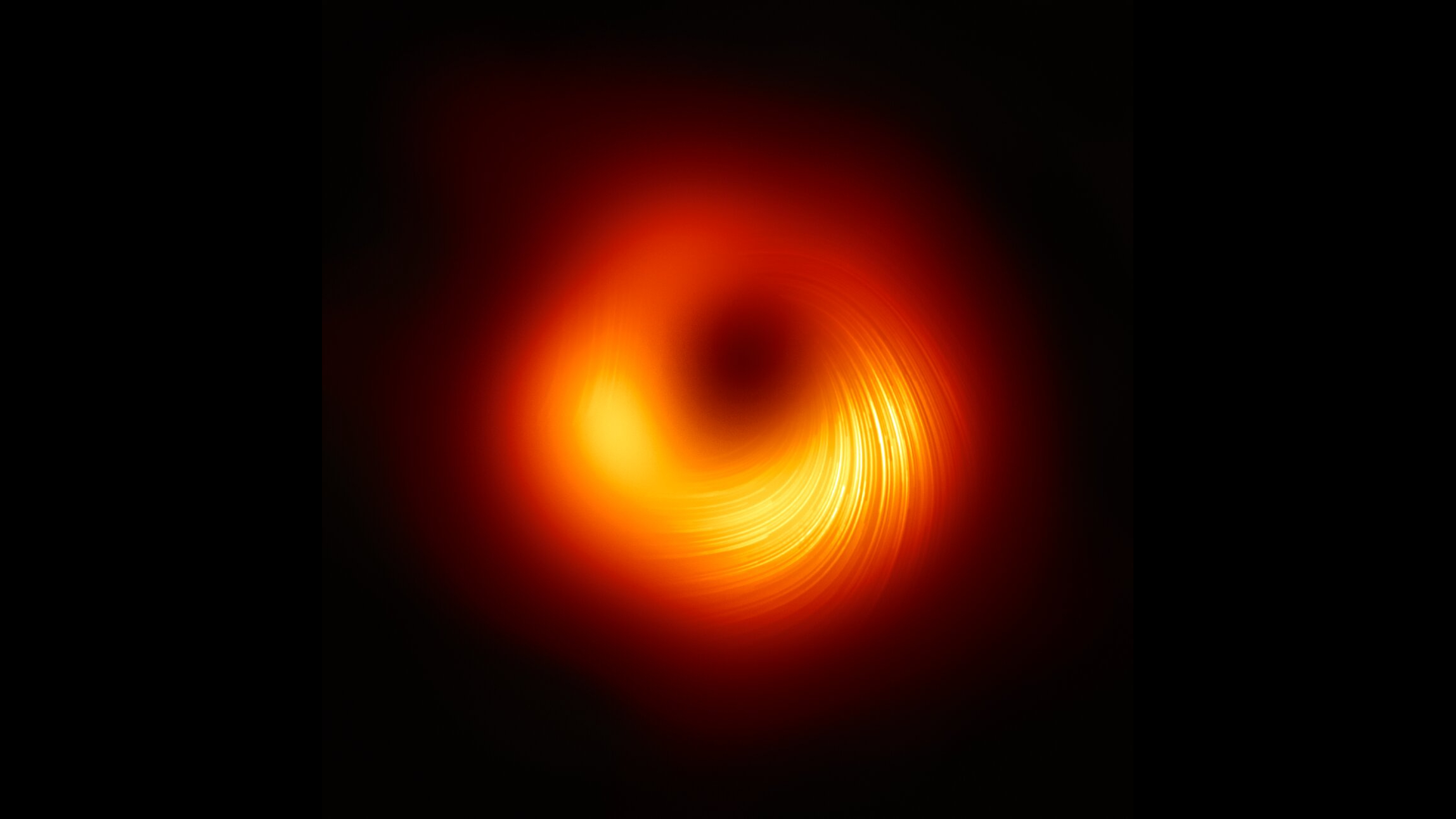 Orange glowing ring with lines of light within surrounding a black circle.