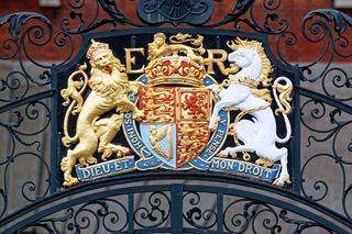 The coat of arms of the United Kingdom features a lion representing England lion on the left and a unicorn representing Scotland on the right.