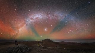 The night sky above the European Southern Observatory's (ESO) Paranal Observatory in Chile is ablaze with vibrant airglow in this gorgeous view by astrophotographer Yuri Beletsky. This colorful phenomenon happens because atoms and molecules in Earth's atmosphere interact and emit radiation. For this reason, the sky is never completely dark. Airglow is only visible in places that are far enough from human-made light pollution, like the Paranal Observatory. This image was captured from ESO's Visible and Infrared Survey Telescope for Astronomy (VISTA), and in the distance you can barely see the Very Large Telescope (VLT), which sits on top of Cerro Paranal.