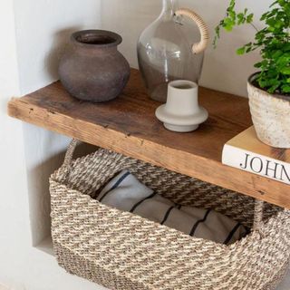 A wicker basket on wooden shelves