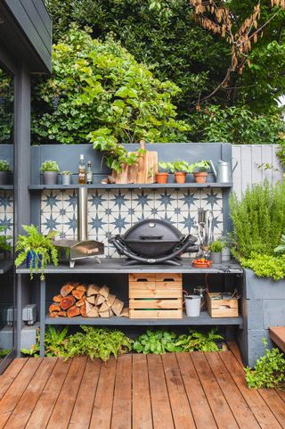 An outdoor kitchen with a grill and star tiled background