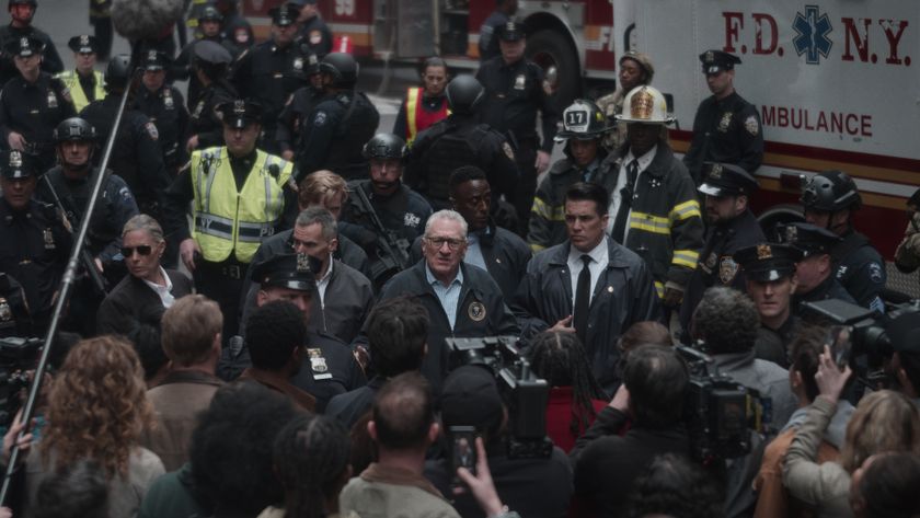 Robert De Niro as George Mullen addressing a crowd and reporters, with police and firefighters in the background. 