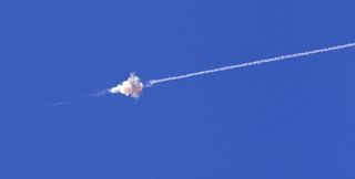 An Israeli Iron Dome interceptor blasts apart a missile fired from the Gaza Strip.