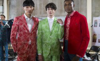 Male models wearing the Richard James collection for Spring / Summer 2016 with stylised colorful hibiscus blooms from deep within the Mexican jungle