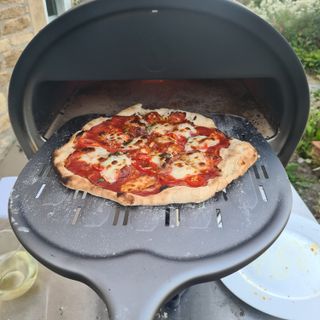 Putting a pizza into the Gozney Roccbox