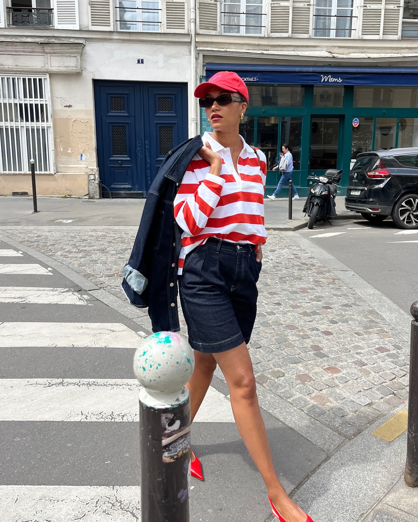Woman wearing long denim bermuda short.