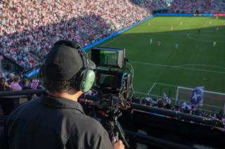Shot of a man shooting a MLS match with an iPhone on a production rig. 