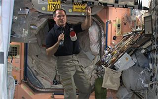 NASA astronaut Kevin Ford holds a packet of smoked turkey that will up part of the space station crew's Thanksgiving feast on Nov. 22, 2012.