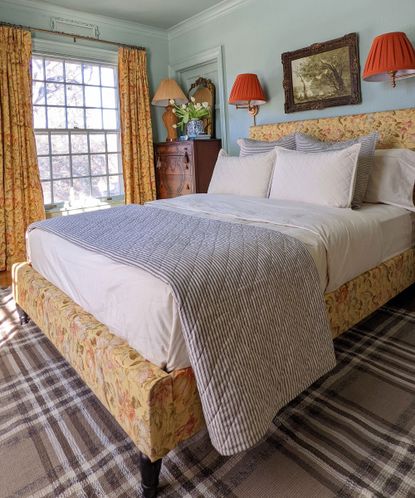 Guest bedroom with vintage gold hued curtains