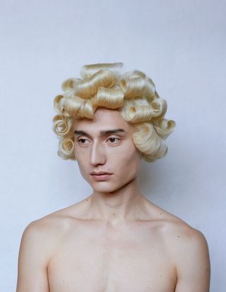 man with curled blond hair