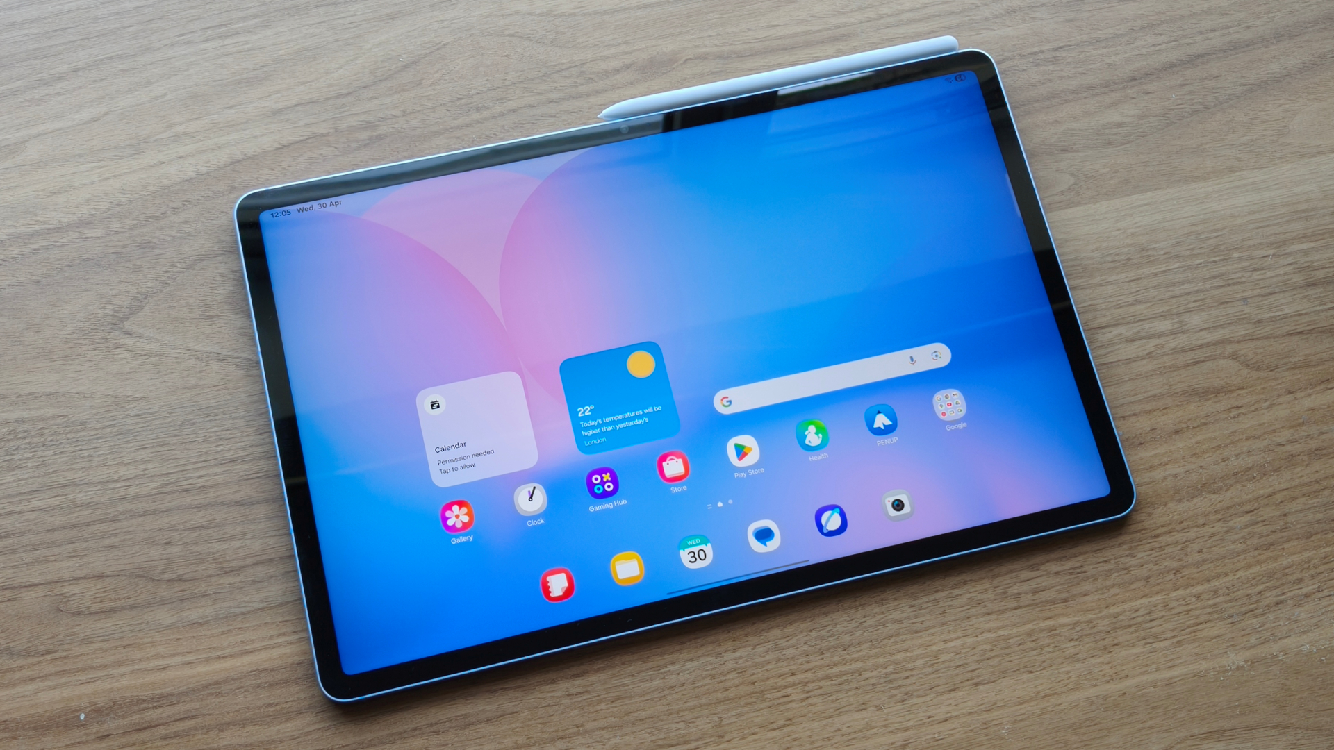 The Samsung Galaxy Tab S10 FE Plus open to the home screen, S Pen attached at the top of the tablet