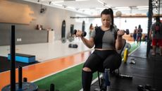 Woman performing dumbbell exercises at a gym
