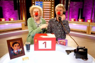 Noel Edmunds and Catherine Tate posing on the set of Deal or No Deal in 2007 for Red Nose Day