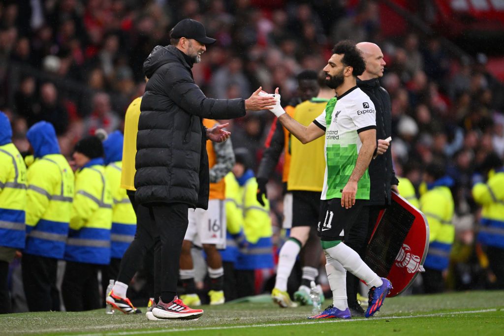 Jurgen Klopp, Manager of Liverpool, shakes hands with Mohamed Salah of Liverpool as he leaves the field after being substituted during the Emirates FA Cup Quarter Final between Manchester United and Liverpool FC at Old Trafford on March 17, 2024 in Manchester, England. (Photo by Stu Forster/Getty Images)