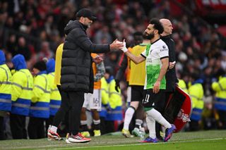 Jurgen Klopp, Manager of Liverpool, shakes hands with Mohamed Salah of Liverpool as he leaves the field after being substituted during the Emirates FA Cup Quarter Final between Manchester United and Liverpool FC at Old Trafford on March 17, 2024 in Manchester, England. (Photo by Stu Forster/Getty Images)