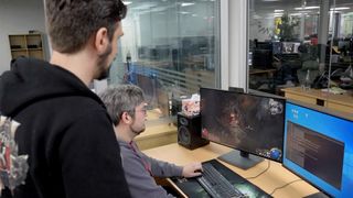 Developers at Grinding Gear Games playing an in-development build of Path of Exile 2.