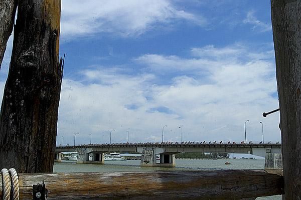The peloton cross a bridge near Baharu still in pursuit of Korean Hyo Suk Gong who had broken clear earlier in the day.