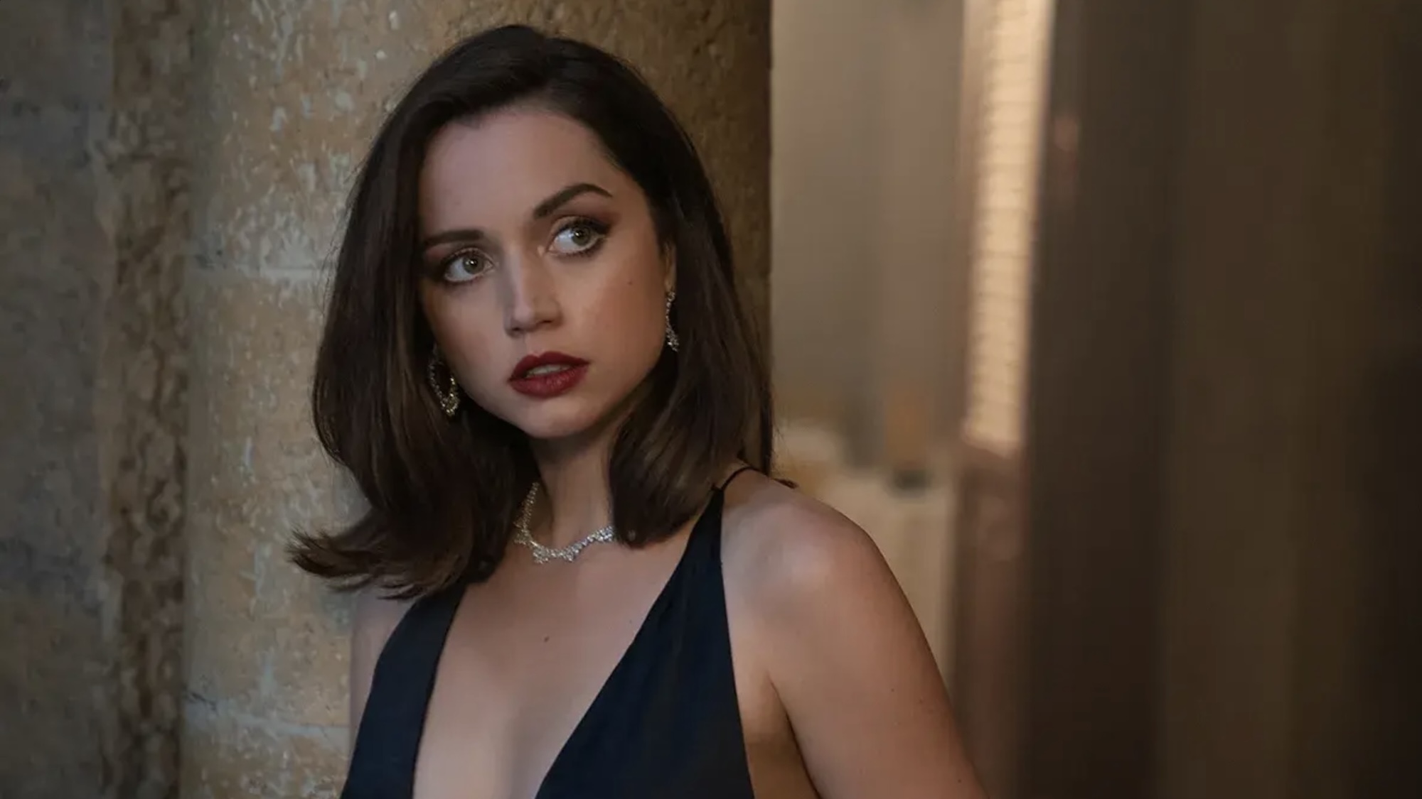 Ana de Armas in a plunging black dress in a promo photo for No time to Die.