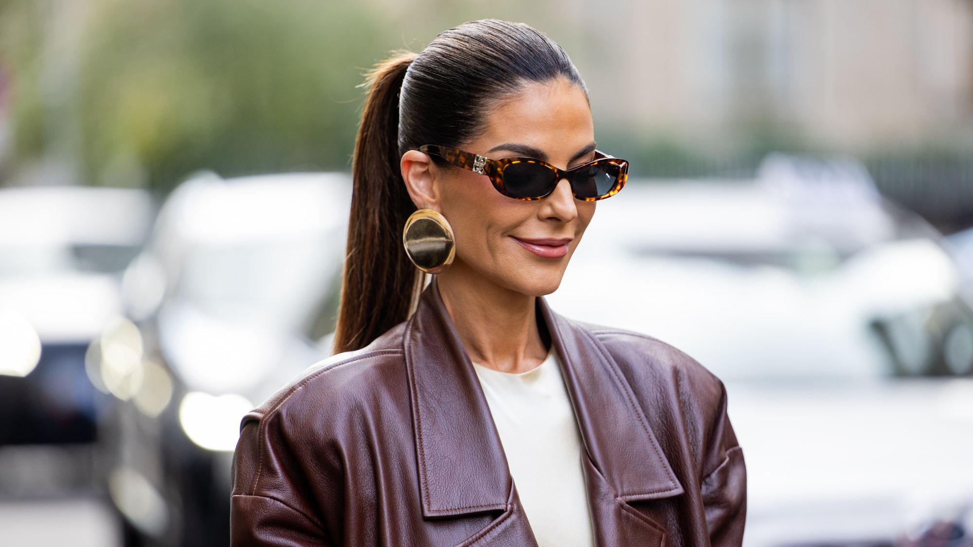 street style shot of woman with glossy lips and high ponytail