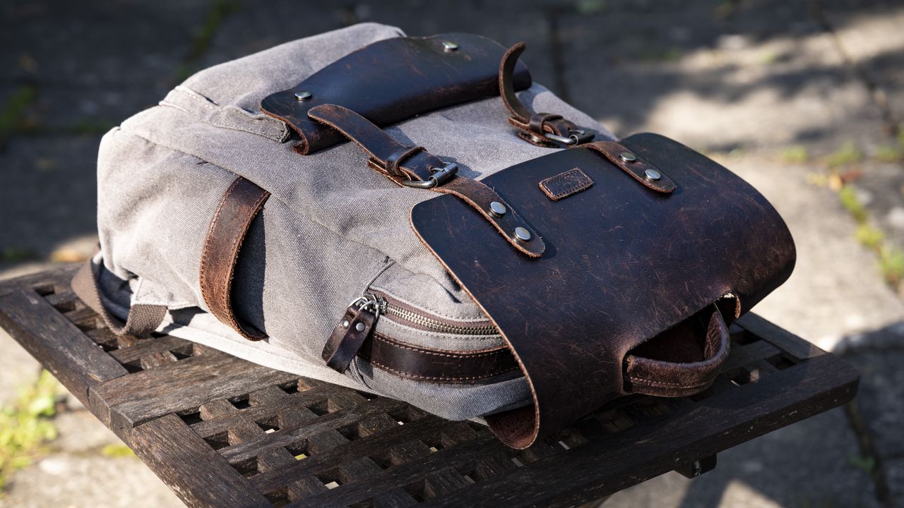 Regular satchel with Peak Design Camera Cubes inside on wooden table outside