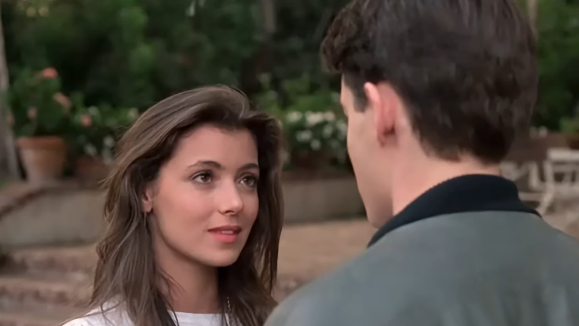 Mia Sara looking at Matthew Broderick (whose back is to the camera) in Ferris Bueller's Day Off