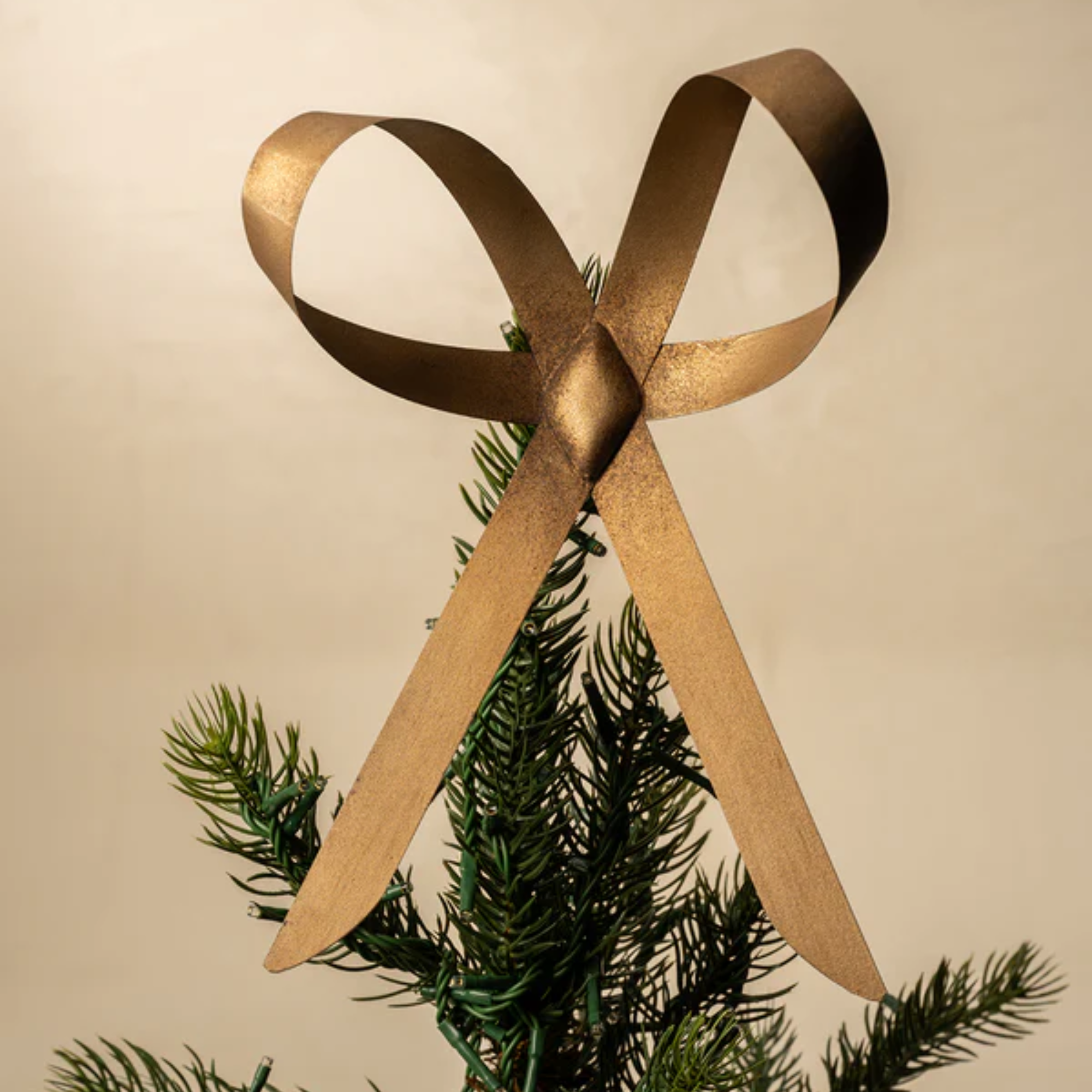 a gold tree topper bow