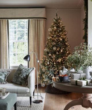 classic christmas tree in modern living room with white lights