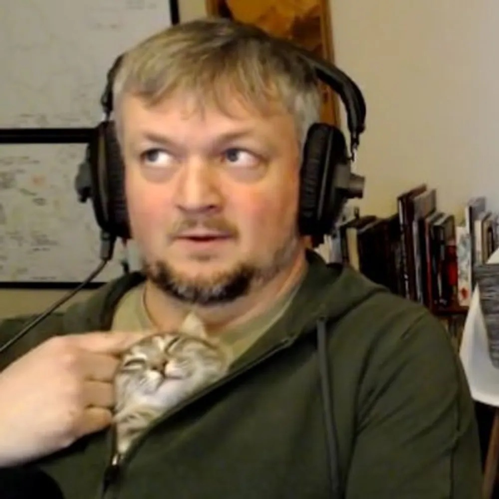 Developer Jack Monahan with a cat tucked into his hoodie.
