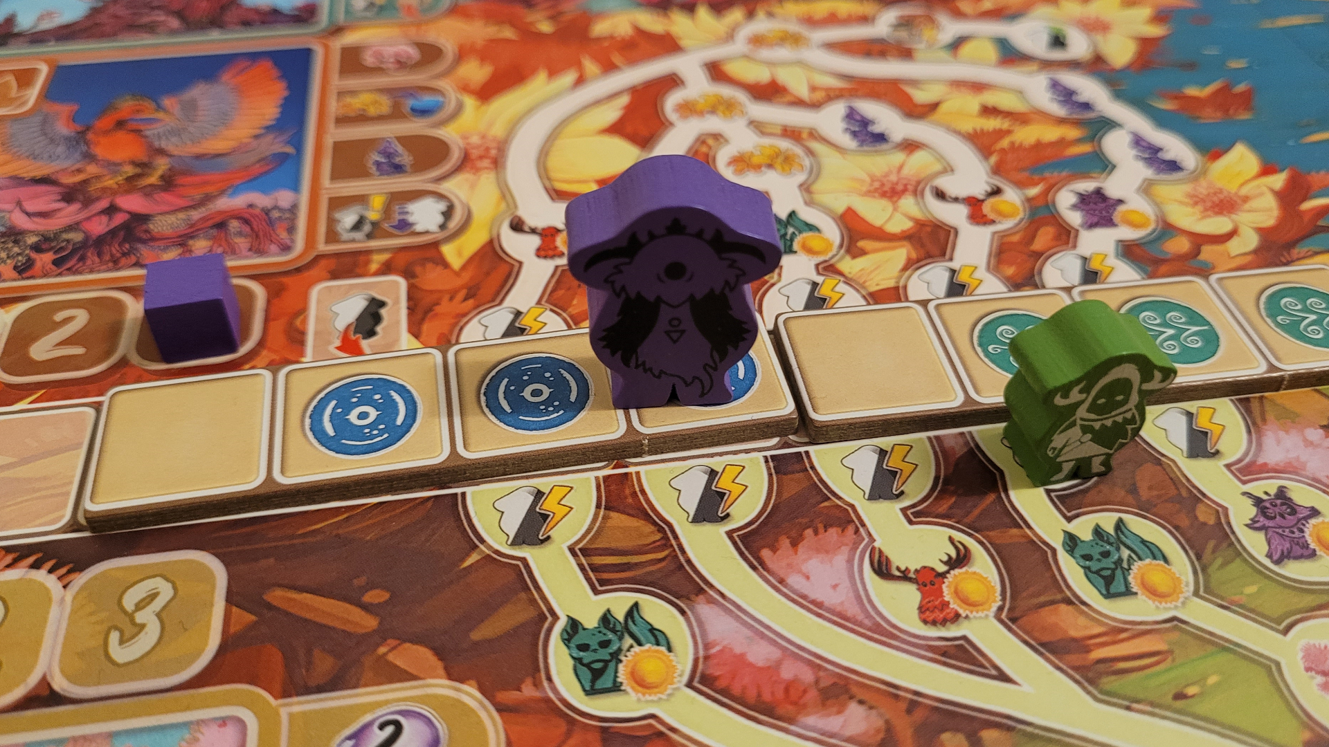 Colorful wooden meeples on the Arborea board