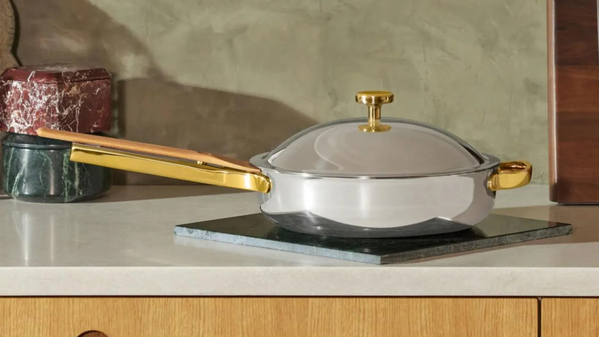 Our Place Titanium Pro on a sleek modern kitchen counter surrounded by marble accessories