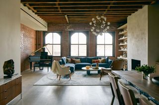 Three arched windows bring natural light into penthouse living room