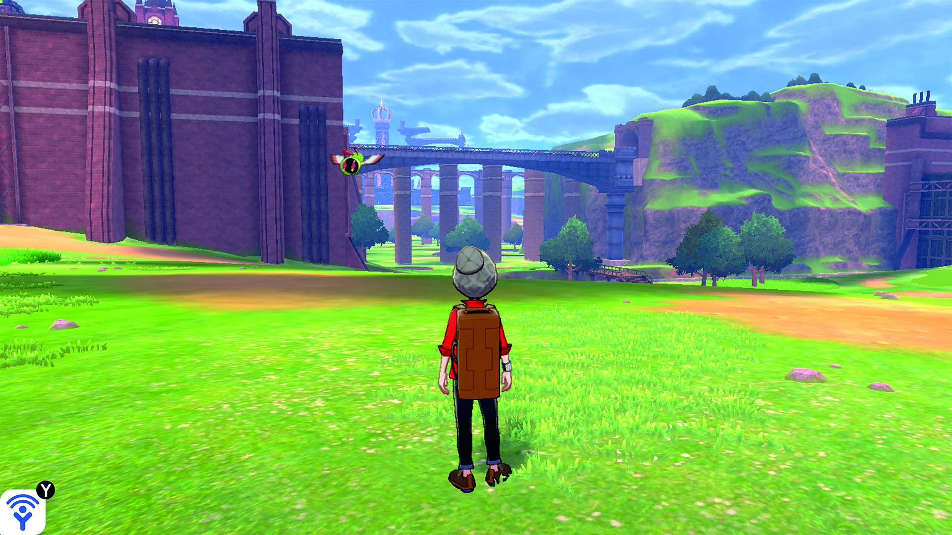 The player explores a large green field - from Pokemon Sword and Shield's entry in The Story of Pokemon bookazine