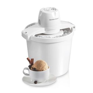 The Hamilton Beach ice cream maker with a curved white base and lid, and a cup of brown ice cream