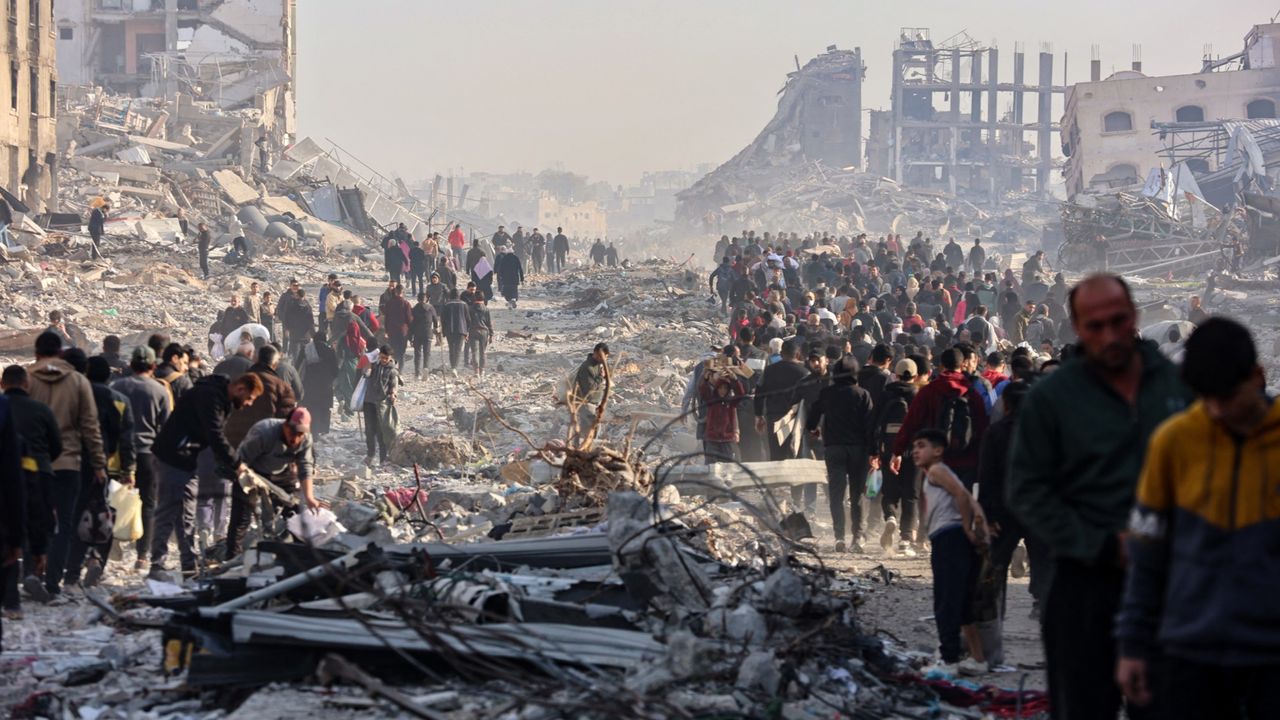 Displaced Palestinians walk along a road in Gaza City on Jan. 19, 2025.