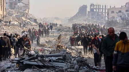 Displaced Palestinians walk along a road in Gaza City on Jan. 19, 2025.