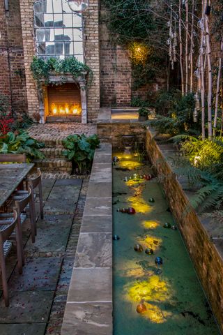 patio garden in the city has ponds and fountains at different heights