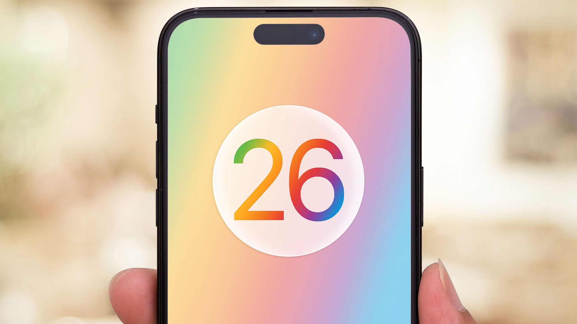 A render of the Apple iOS 26 logo on an iPhone held in a hand.