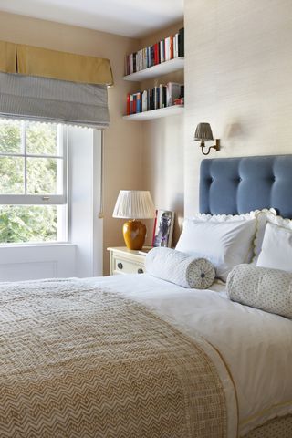 small bedroom with soft pelmet and upholstered blue bedhead