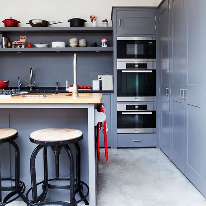 Kitchen makeover with grey Plain English units and concrete floors ...