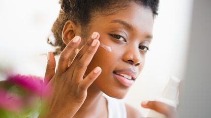 travel-sized sunscreen - Woman putting on sunscreen