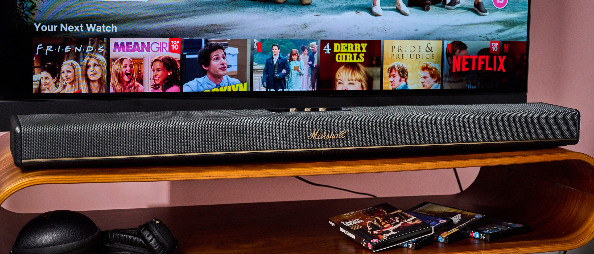 Marshall Heston 120 below TV with Marshall headphones and 4K UHD Blu-rays below that