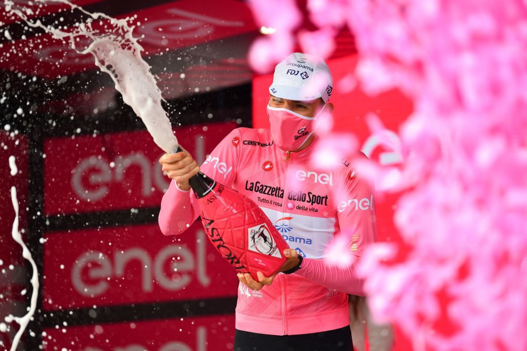 Team GroupamaFDJ rider Hungarys Attila Valter celebrates his overall leaders pink jersey with champagne as he stands on the podium after the eighth stage of the Giro dItalia 2021 cycling race 170 km between Foggia and Guardia Sanframondi on May 15 2021 Photo by Dario BELINGHERI POOL AFP Photo by DARIO BELINGHERIPOOLAFP via Getty Images