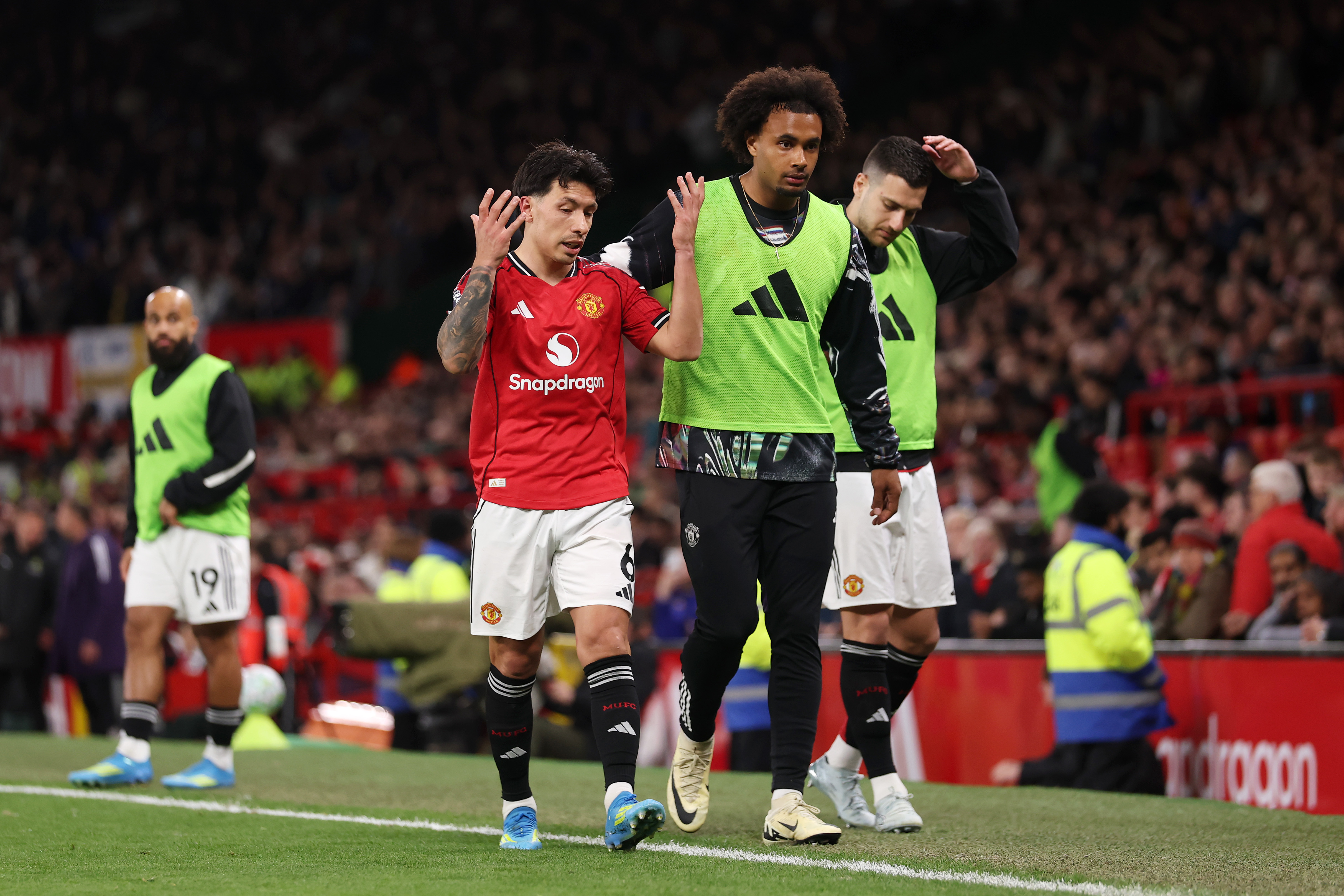 Lisandro Martinez of Manchester United looks dejected as he is consoled by team mate Joshua Zirkzee after being shown a red card for pulling the hair of Dominic Calvert-Lewin of Leeds United