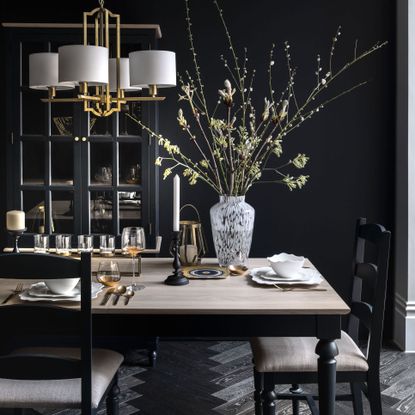 dark dining room with table and cupboard