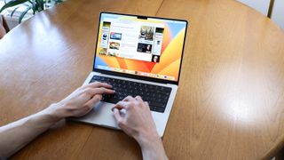 hands typing on a apple macbook pro laptop with m2 pro silicon