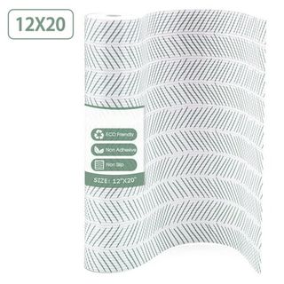 A roll of white cabinet liner with gree angled line pattern on it