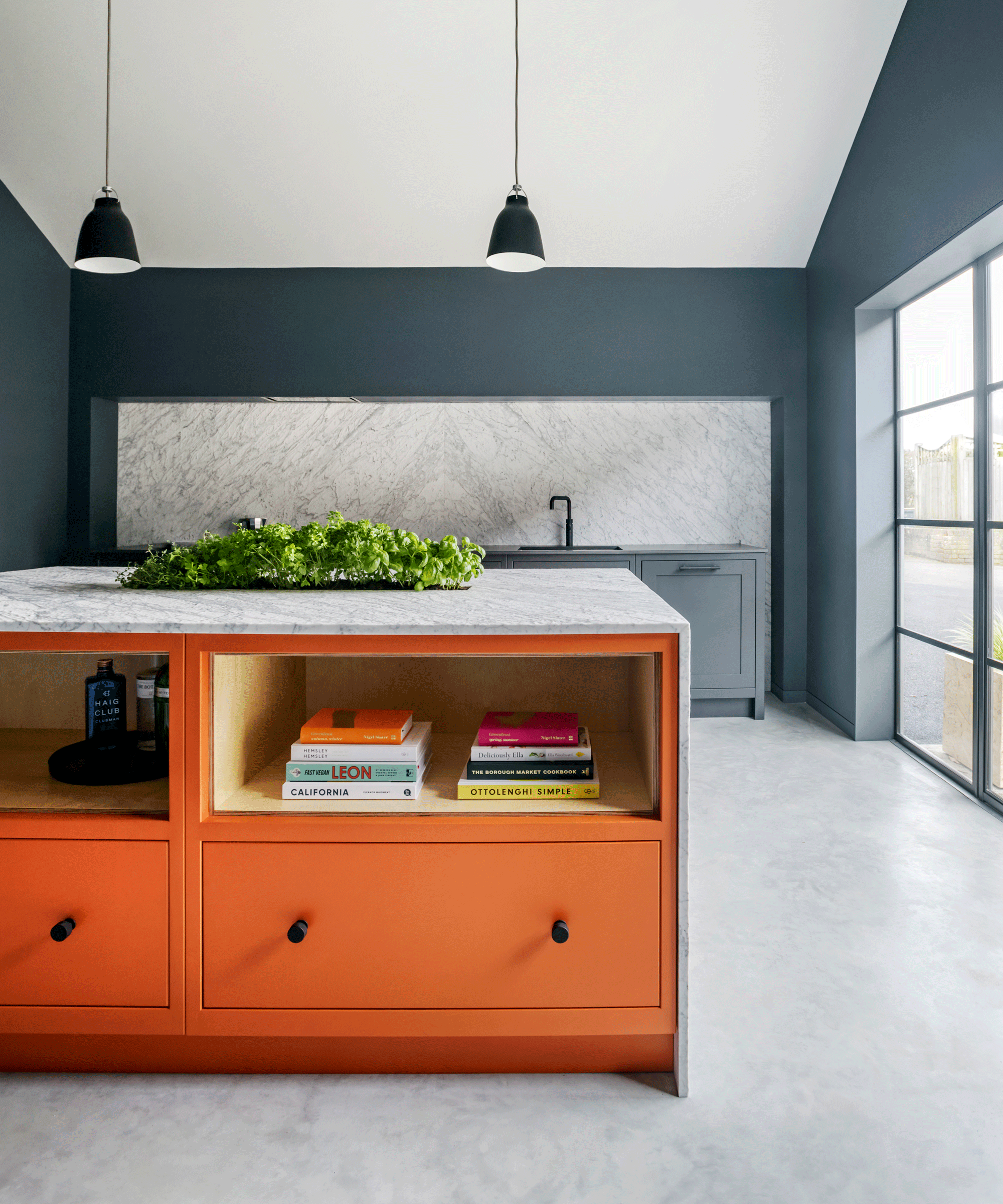 Two-tone kitchen with grey cabinets and bright orange island