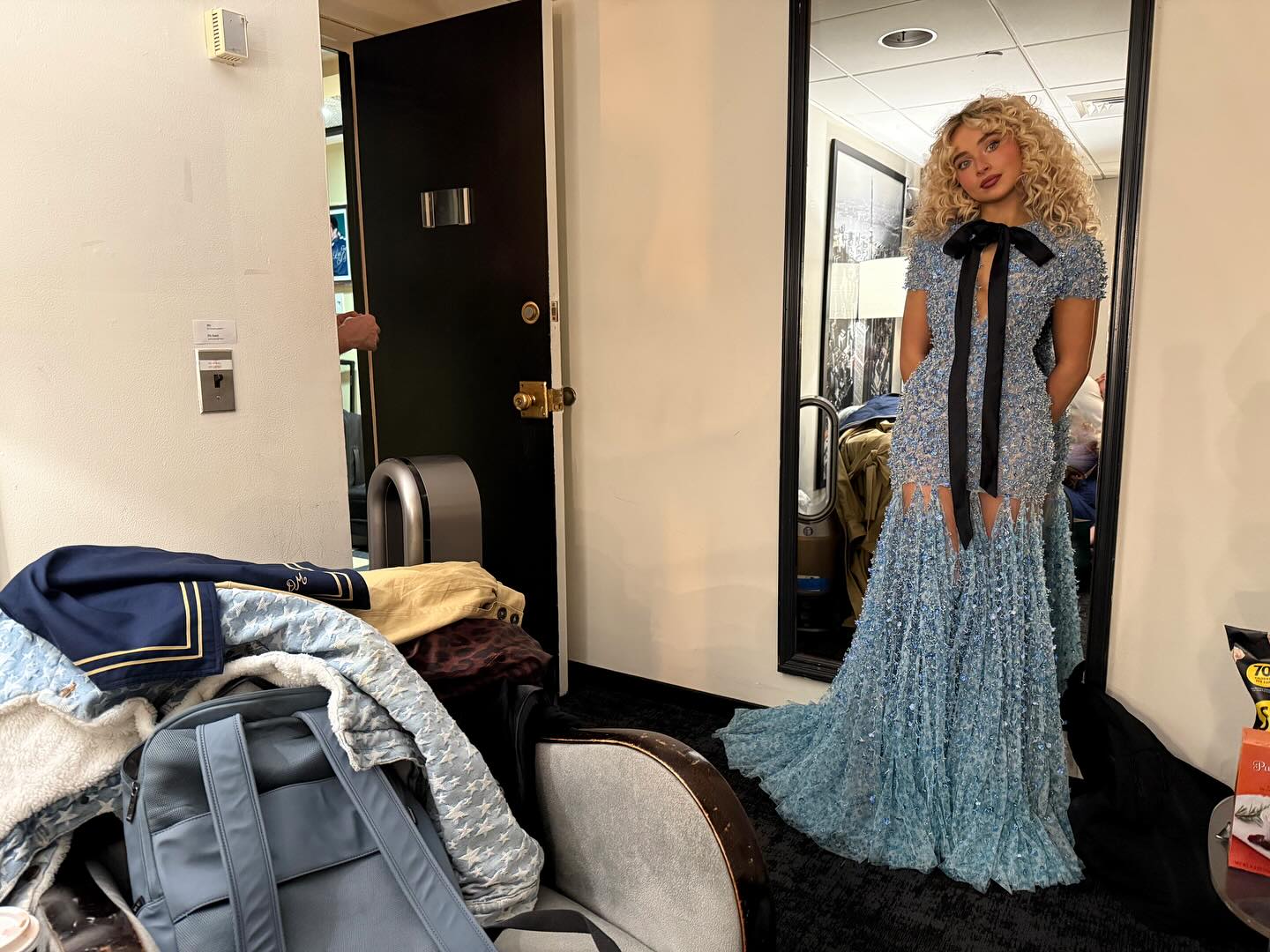 Sabrina Carpenter wearing a sculptural corset and posing with a Chloe Paddington