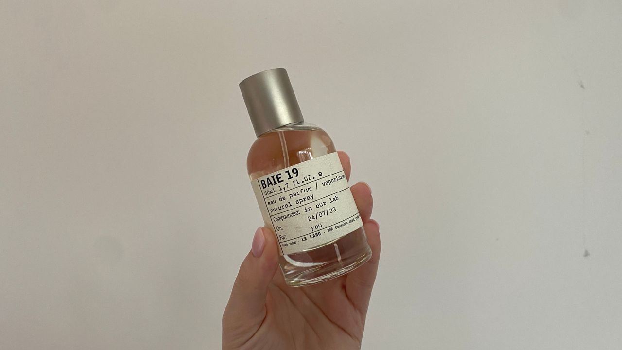 Hand holding bottle of Le Labo Baie 19 Eau de Parfum